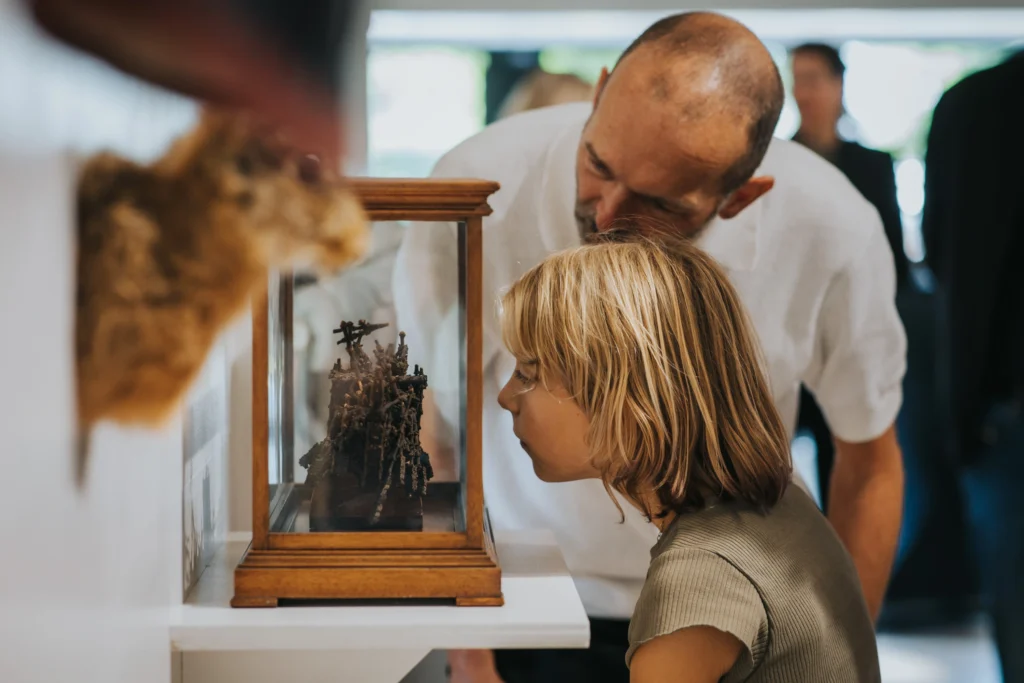 Man and child viewing museum exhibit together
